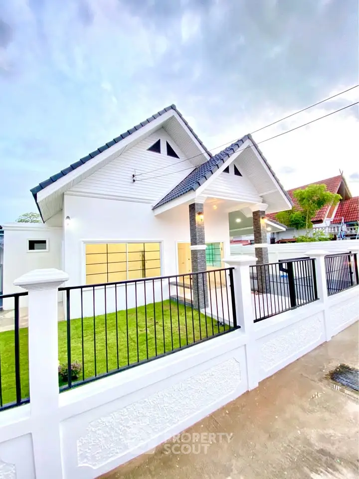 Charming modern house with pitched roof and fenced yard, perfect for family living.