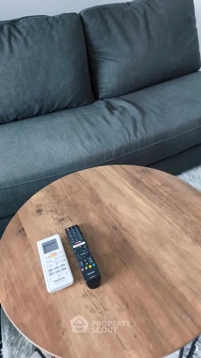 Modern living room with stylish gray sofa and wooden coffee table, perfect for cozy relaxation.