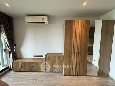 Modern bedroom with sleek wooden furniture and air conditioning