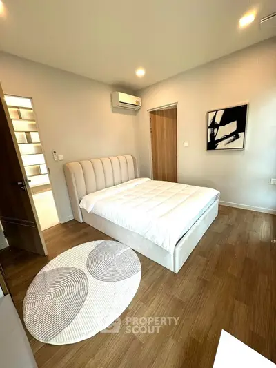 Modern bedroom with stylish decor and wooden flooring