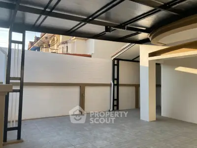 Spacious covered patio area with modern design and ample natural light.