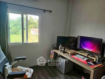 Cozy study room with dual monitors and garden view, perfect for remote work.