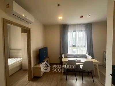 Modern living room with dining area and bedroom view in a cozy apartment