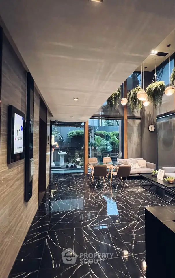 Luxurious modern lobby with elegant marble flooring and stylish seating area.