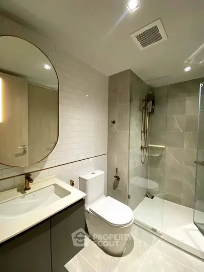 Modern bathroom with sleek fixtures and glass shower enclosure