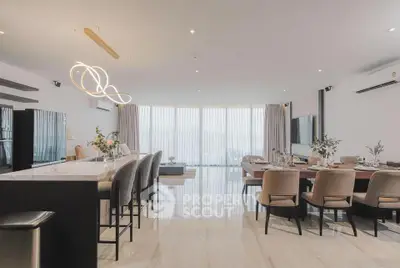 Luxurious open-plan living and dining area with modern lighting and elegant decor