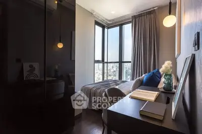 Modern bedroom with city view, featuring sleek desk and cozy bed setup.