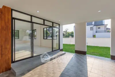 Modern open-plan living space with large windows and garden view, perfect for natural light and outdoor connection.