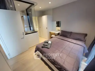 Modern bedroom with cozy bed and stylish decor in a contemporary apartment.