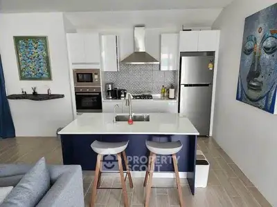 Modern kitchen with sleek appliances and stylish decor in a contemporary apartment.