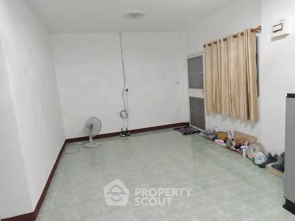Spacious empty room with tiled floor and curtain, ideal for customization