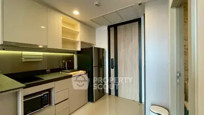 Modern kitchen with sleek cabinetry, built-in appliances, and stylish lighting.