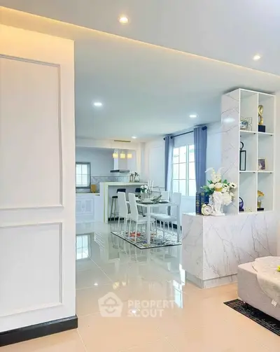 Elegant open-plan living and dining area with modern decor and bright natural lighting.