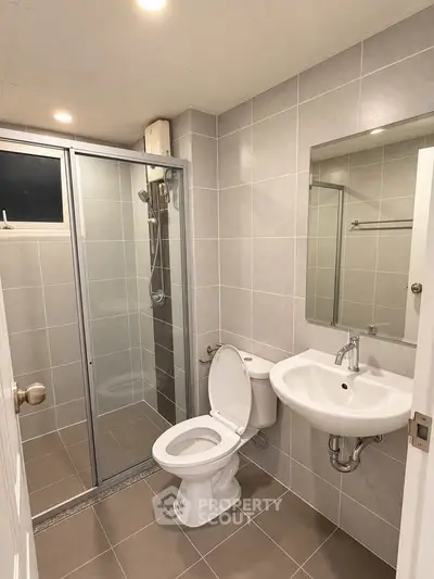 Modern bathroom with glass shower and sleek fixtures