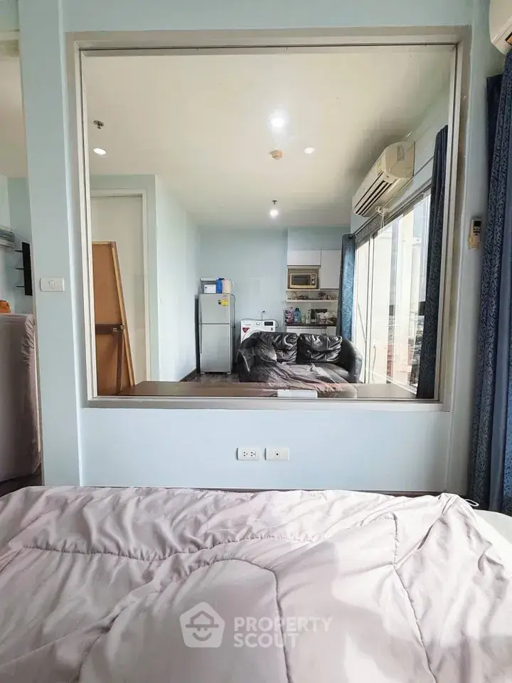 Modern studio apartment with open layout and large window view