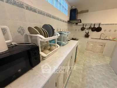 Spacious kitchen with modern appliances and ample storage space