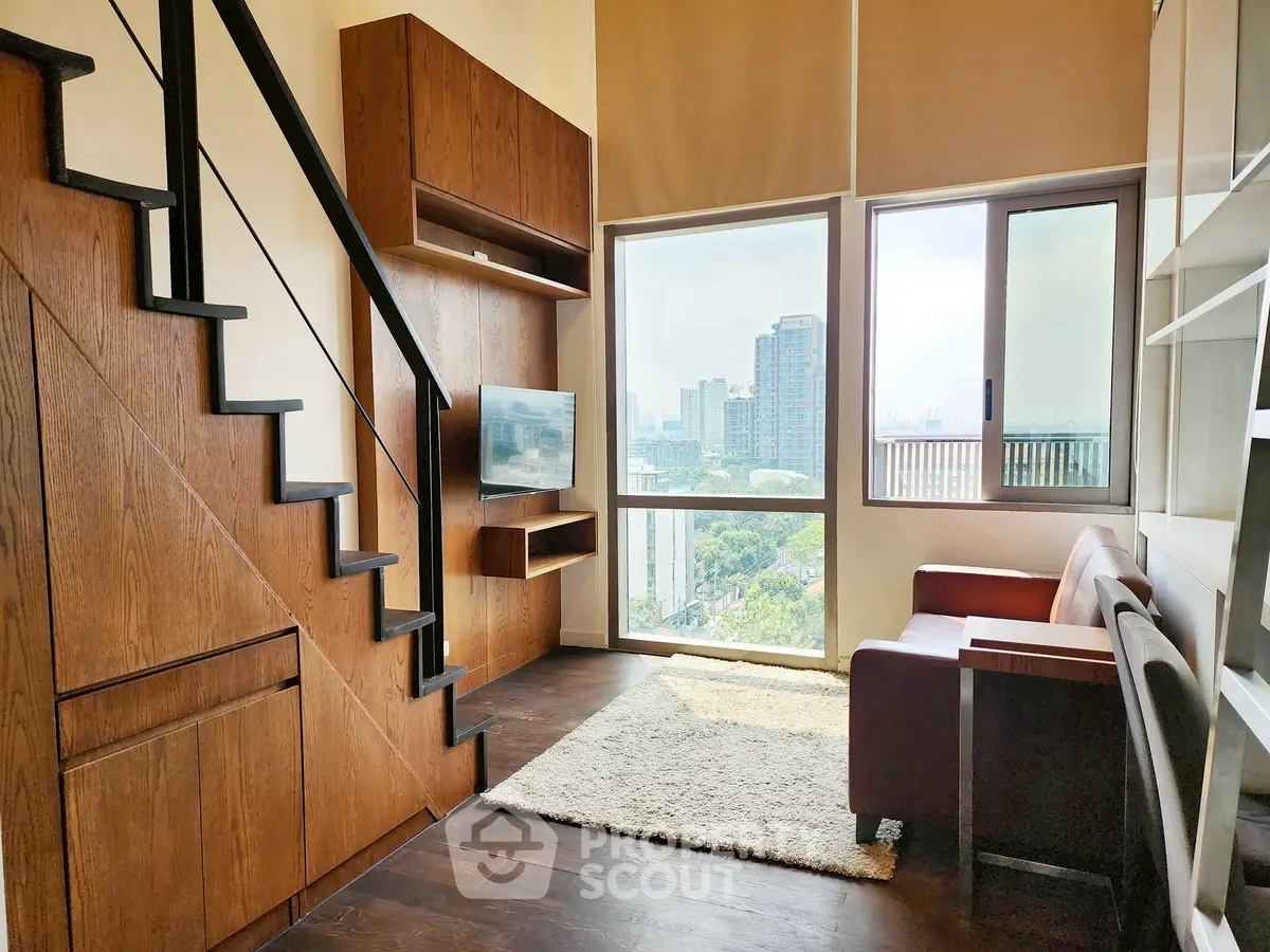 Modern living room with loft stairs and city view, featuring sleek wooden finishes and cozy seating area.