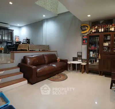 Spacious living room with leather sofa and stylish decor in modern home