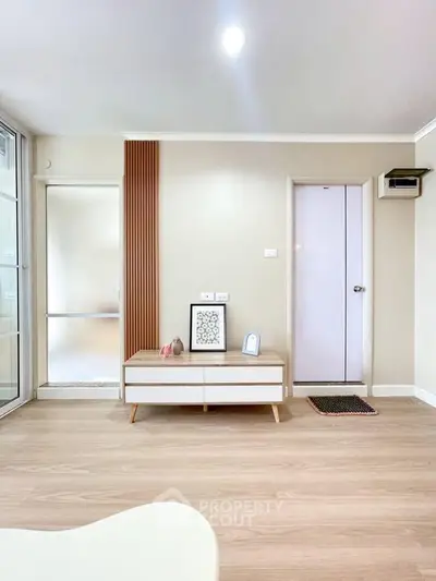 Modern minimalist living room with stylish decor and wooden flooring