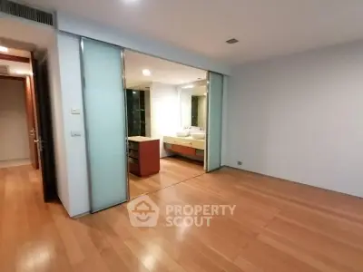 Spacious modern bedroom with ensuite bathroom and wooden flooring