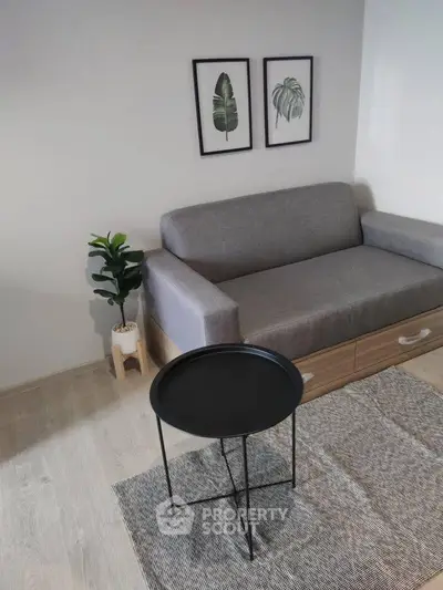 Modern living room with gray sofa, stylish decor, and minimalist design.