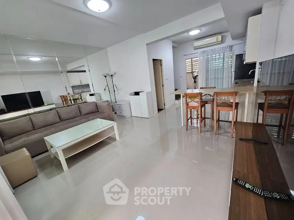 Spacious modern living room with open kitchen and stylish furniture