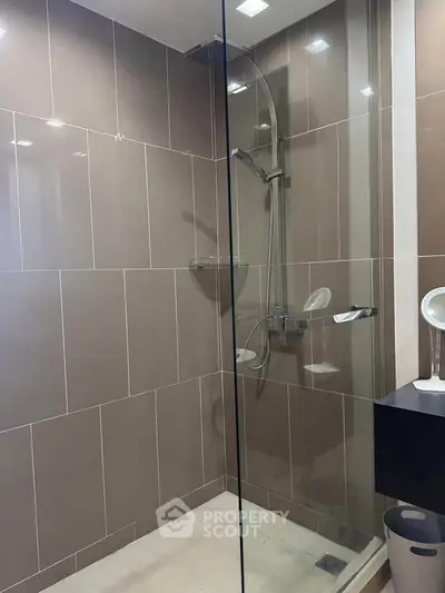 Modern bathroom with sleek glass shower and stylish tile design.
