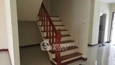 Spacious interior with elegant wooden staircase in modern home