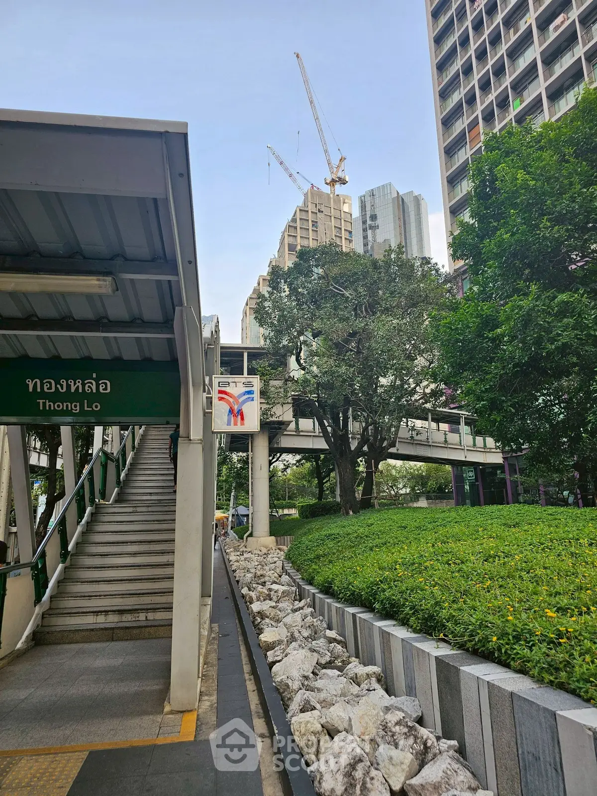 Modern urban landscape near Thong Lo with lush greenery and high-rise buildings.