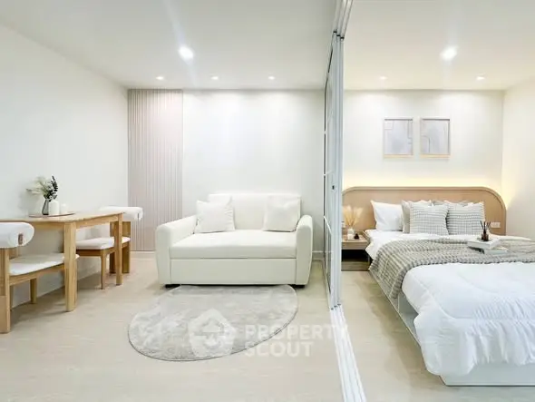 Modern studio apartment with cozy living area and stylish bedroom, featuring elegant decor and soft lighting.