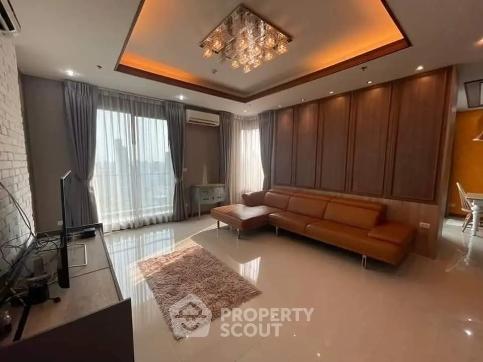 Luxurious living room with modern decor, leather sofa, and large windows offering abundant natural light.