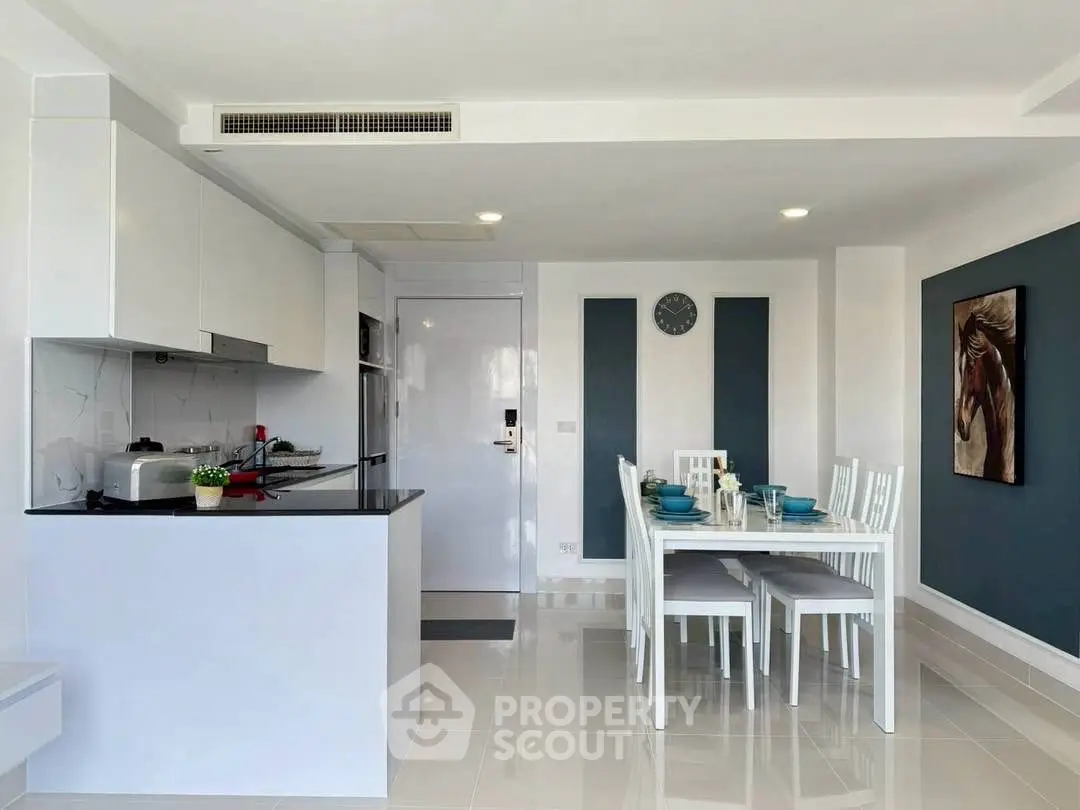 Modern dining area with sleek kitchen in open layout apartment