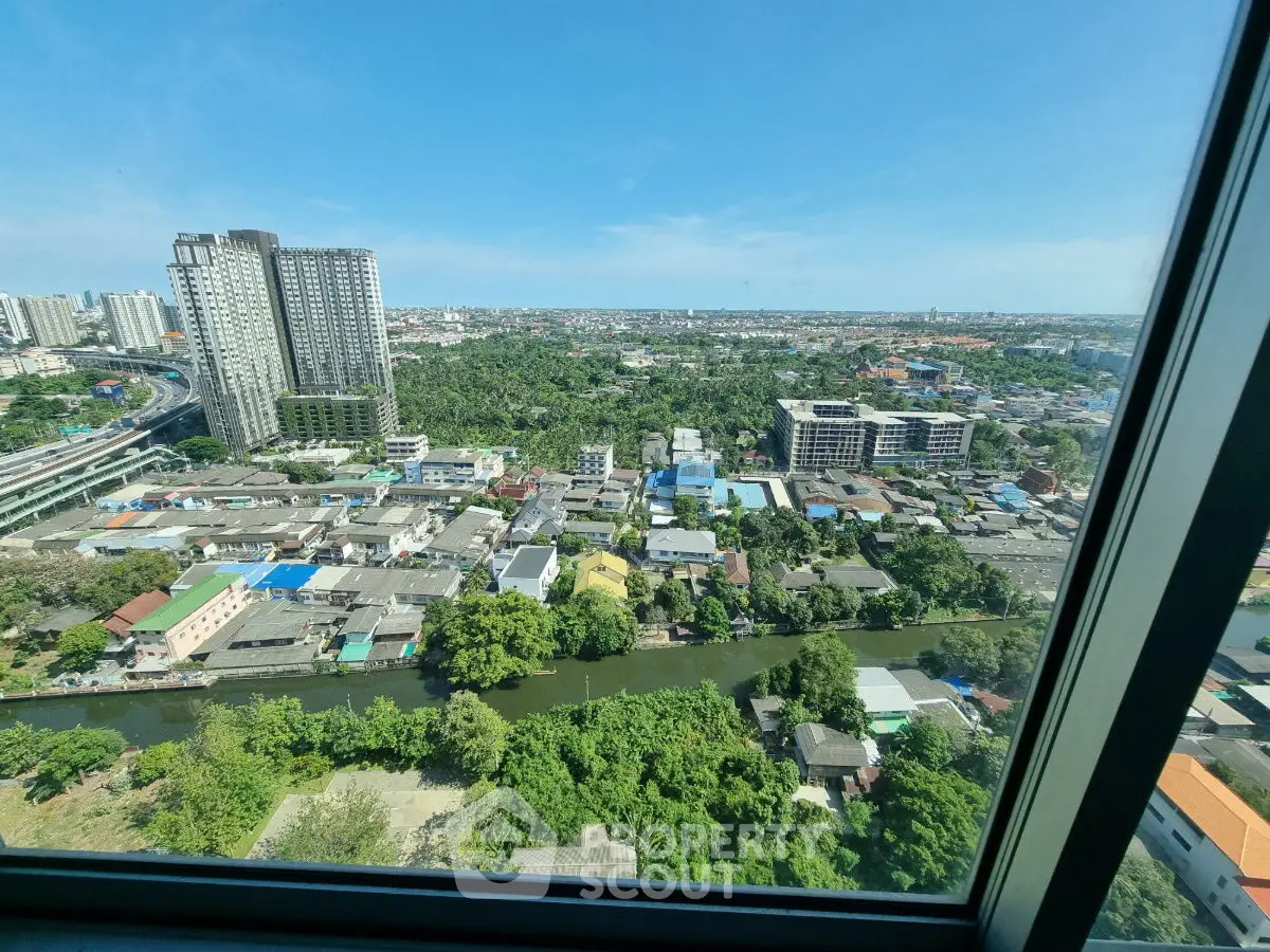 Stunning high-rise view of cityscape and greenery from a window