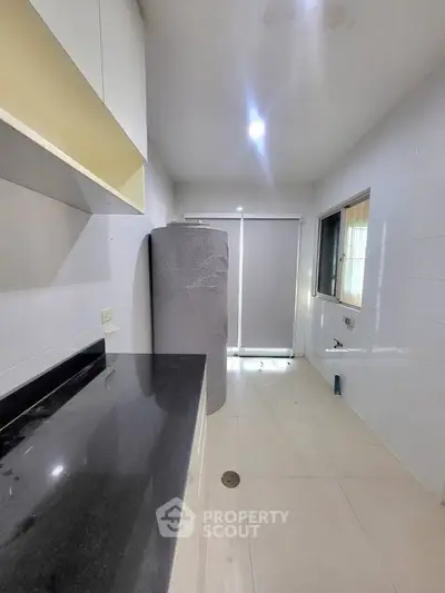 Spacious kitchen with sleek countertops and ample natural light