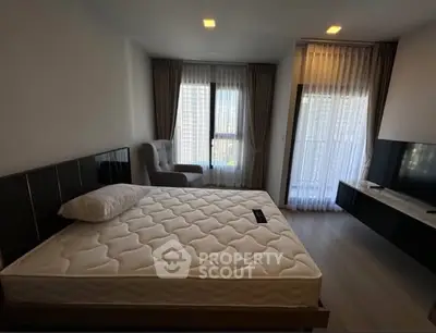 Modern bedroom with large window and stylish furnishings