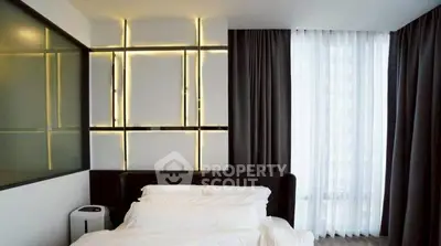 Modern bedroom with stylish lighting and floor-to-ceiling windows