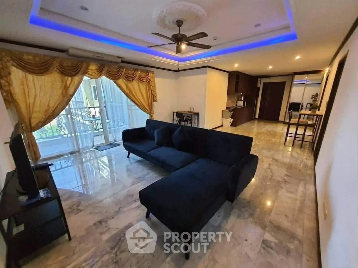 Spacious living room with modern decor and elegant lighting