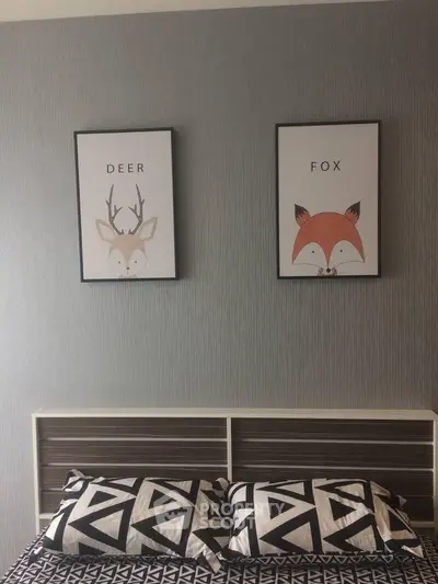 Stylish bedroom with modern decor and animal-themed artwork above bed.