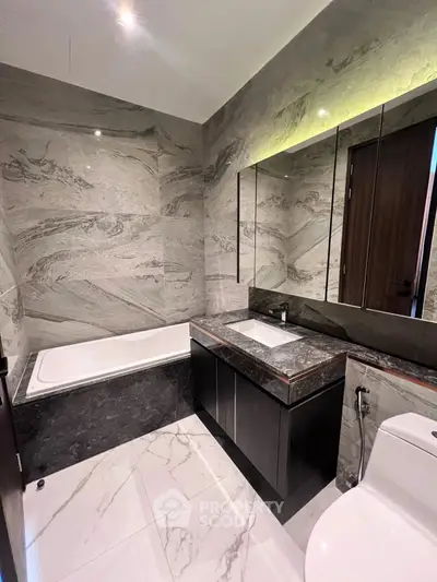 Luxurious marble bathroom with elegant bathtub and modern fixtures