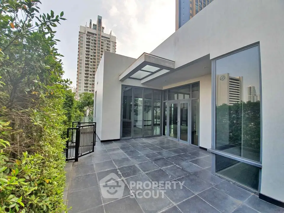 Spacious modern balcony with city view, perfect for relaxation and entertaining guests.