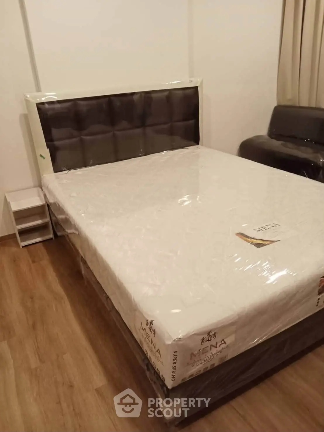 Modern bedroom with new bed and stylish flooring, perfect for a cozy living space.