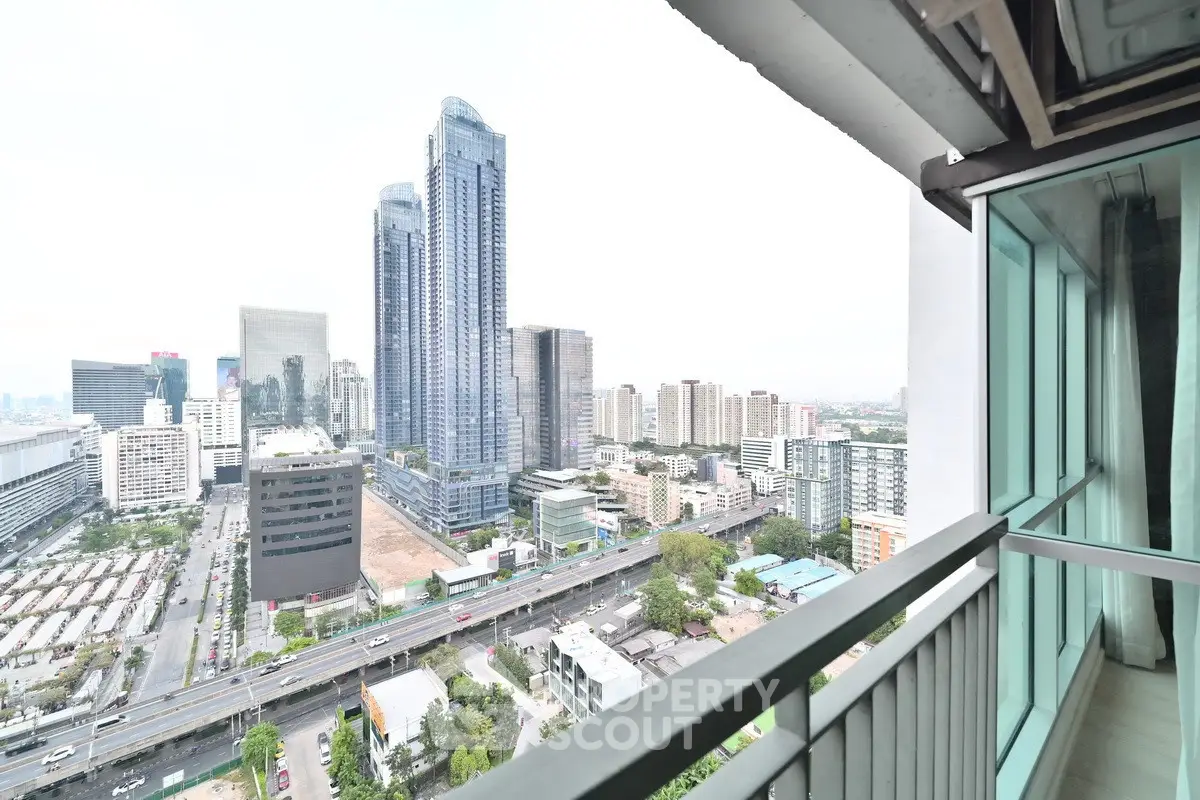 Stunning cityscape view from high-rise balcony in modern urban setting.