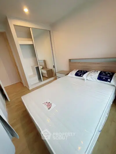 Modern bedroom with mirrored wardrobe and new mattress in stylish apartment