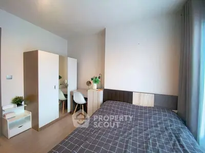 Modern bedroom with stylish decor and ample natural light