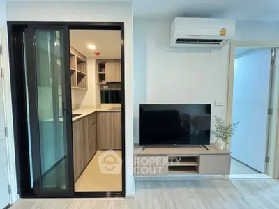 Modern living room with sleek kitchen and air conditioning unit