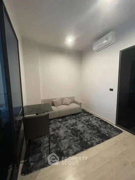 Modern living room with cozy sofa and sleek air conditioning unit