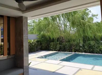 Luxurious outdoor pool area with lush greenery and modern design