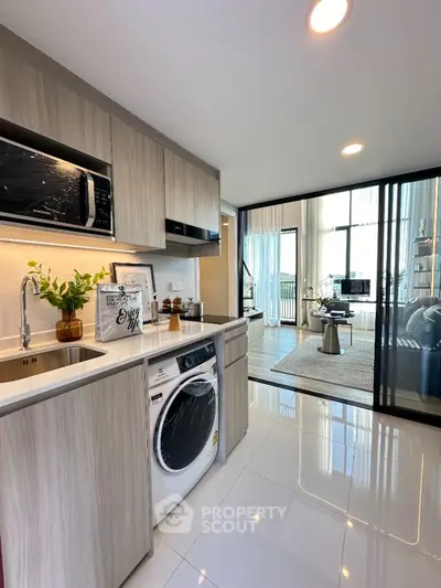 Modern kitchen with sleek cabinetry and integrated appliances in open layout