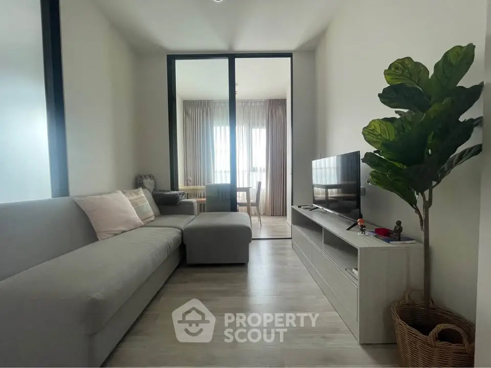 Modern living room with sleek furniture and natural light, perfect for relaxation and entertainment.