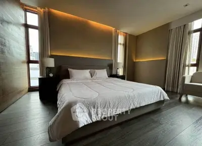 Luxurious bedroom with modern design and large windows offering city views.